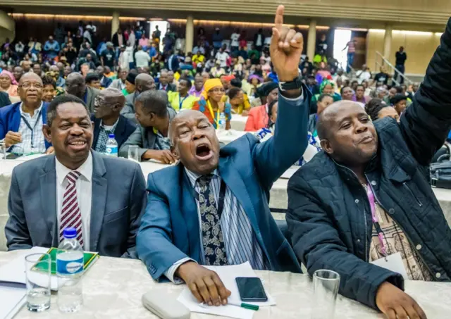 War Veterans leader Christopher Mutsvangwa (C) celebrates the dismissal of the president of the ruling ZANU-PF party on November 19, 2017 in Harare.