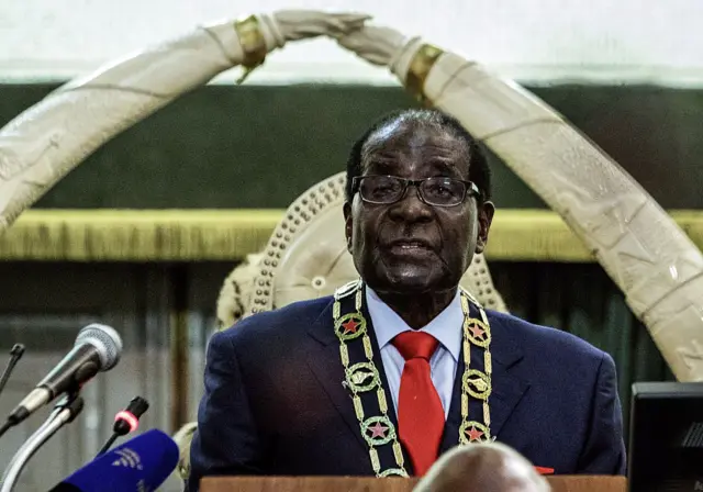 Zimbabwe's President Robert Mugabe delivers his State of the Nation address in Parliament in Harare on August 25, 2015. Zimbabwe's long ruling President Robert Mugabe was booed and heckled by opposition legislators over the deteriorating economy whilst presenting his state of the nation address in parliament