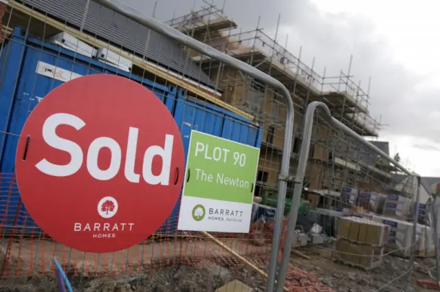 Sold sign on a new-build house