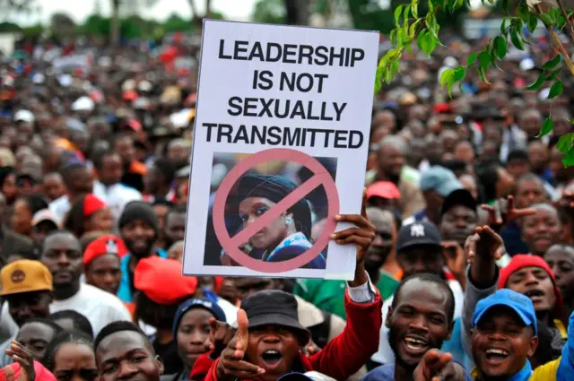 People hold an anti-Grace Mugabe placard during a demonstration demanding the resignation of Zimbabwe's president on November 18, 2017 in Harare.