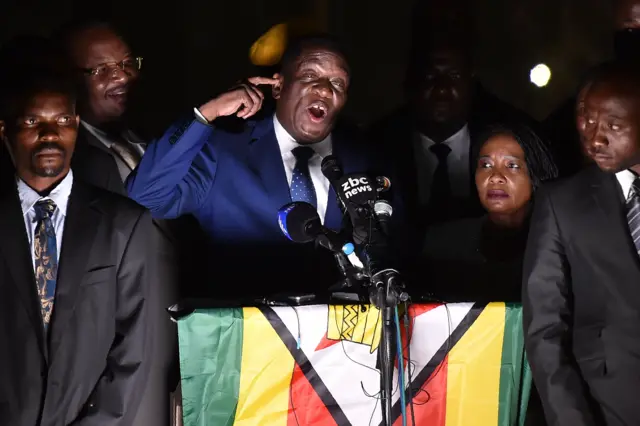 Emmerson Mnangagwa (3rd L) speaks to supporters flanked by his wife Auxilia (2nd R) surrounded by their bodyguards at Zimbabwe"s ruling Zanu-PF party headquarters in Harare on November 22, 2017.