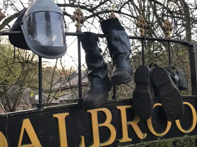 Boots and helmet left on the gates outside Coalbrooksale foundry, Shropshire