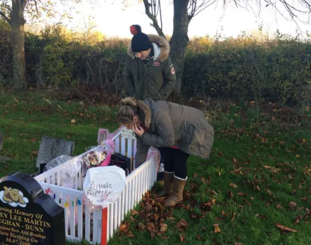 Jason and Stacy Tinmurth by their baby's grave