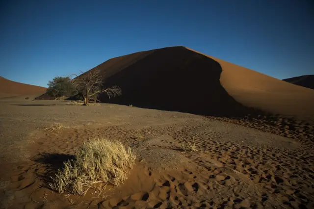 A picture taken on May 13, 2015 the Namibia Naukluft National Park near Sesriem shows red dunes of the salt desert of Sosusvlei.