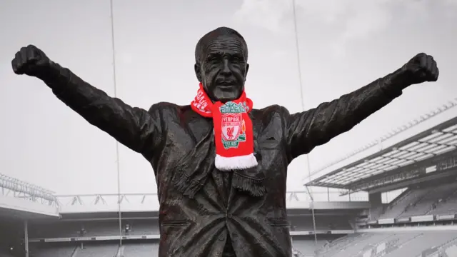 A scarf is wrapped around a statue of Bill Shankly outside Anfield