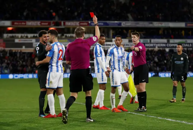 Rajiv van La Parra is shown a red card by Craig Pawson