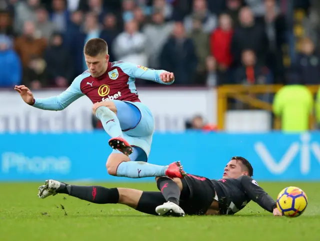 Burnley's Johann Gudmundsson is tackled by Arsenal's Granit Xhaka