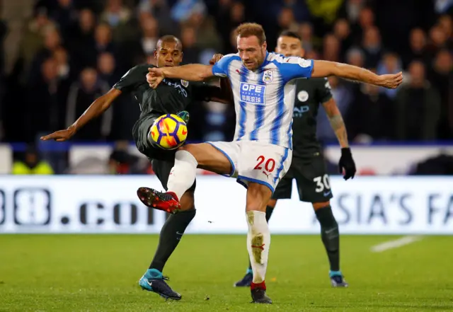 Manchester City's Fernandinho tackles Huddersfield's Laurent Depoitre