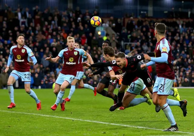 James Tarkowski gives away a penalty after pushing Aaron Ramsey