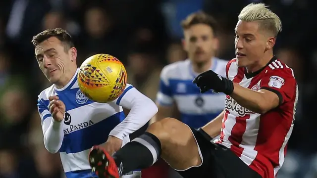 Josh Scowen of Queens Park Rangers battles with Sergi Canos of Brentford