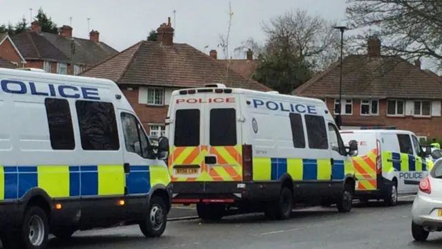 Police vans on road