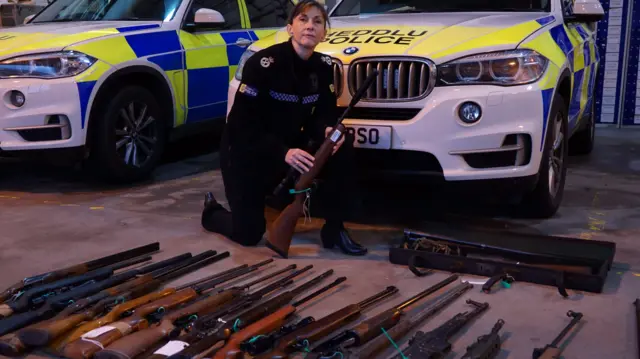 Acting Chief Constable Janette McCormick with some of the surrendered firearms