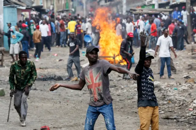 Supporters of the opposition coalition the National Super Alliance (NASA) and its presidential candidate Raila Odinga throw stones at riot police in protest during their running battles with police in Mathare North, Nairobi, Kenya, 20 November 2017