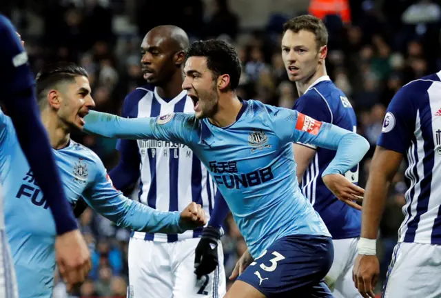 Newcastle players celebrate after Jonny Evans scores an own goal for West Brom