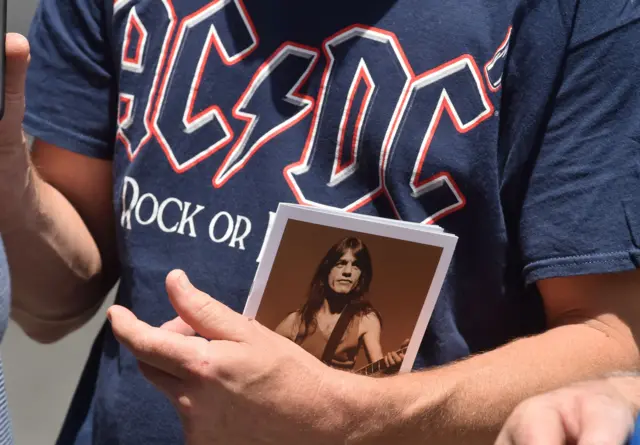 Fans remember Malcolm Young outside funeral