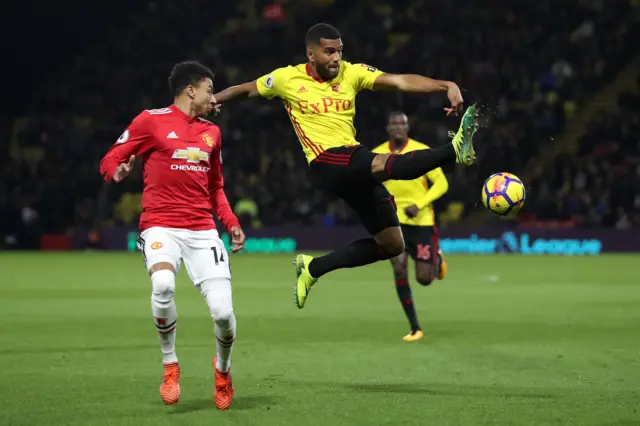 Adrian Mariappa wins the ball ahead of Jesse Lingard