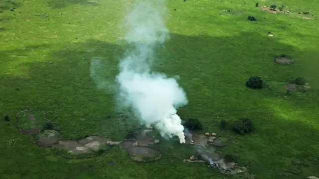 Houses burnt by cattle raiders in a village in Pibor County, in South Sudan's Jonglei state, emit plumes of smoke on July 12, 2013