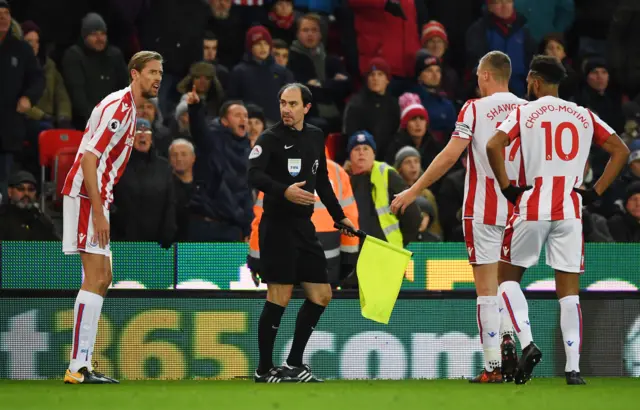 Peter Crouch of Stoke City argues with the linesmen Stephen Child