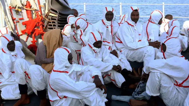 African migrants are seen aboard a rescue ship as they arrive at a naval base in Tripoli on November 25, 2017, after their rubber boat was rescued