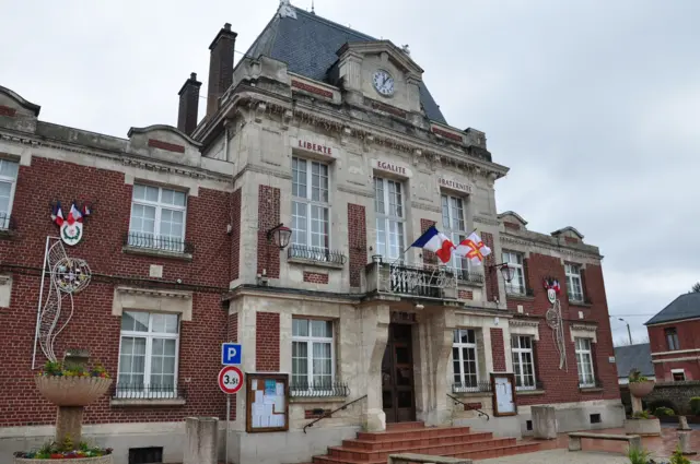 French and Guernsey flags flying outside the Masnieres Town Hall