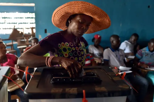 A woman casts her ballot as she votes at a polling station in Monrovia during presidential elections on October 10, 2017