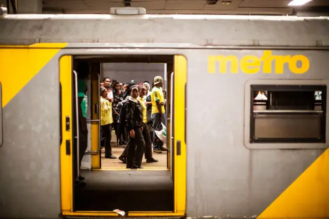 Commuters gather on a platform at the Johannesburg Park Station on March 17, 2017.