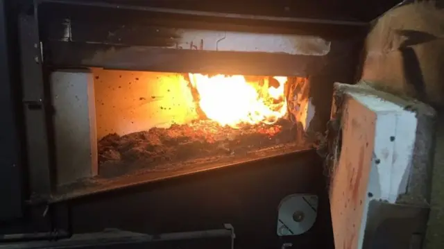 Wood pellets burning in a biomass boiler