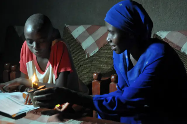 Mother and son with Kerosene lamp