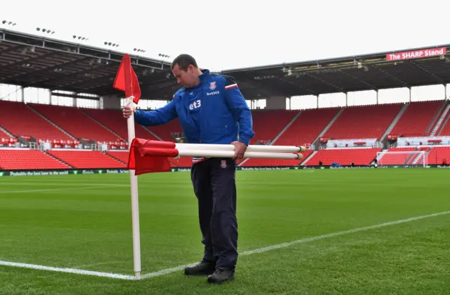 man puts flags in pitch