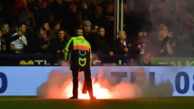 A fire had to be put at Ewen Fields following the release of the flare during the Hyde-MK Dons FA Cup first round tie