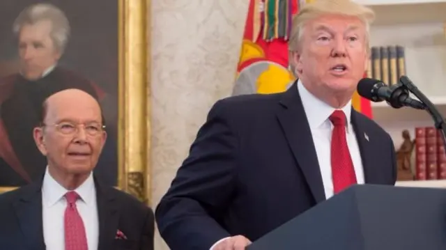 US President Donald Trump speaks alongside Secretary of Commerce Wilbur Ross (L)