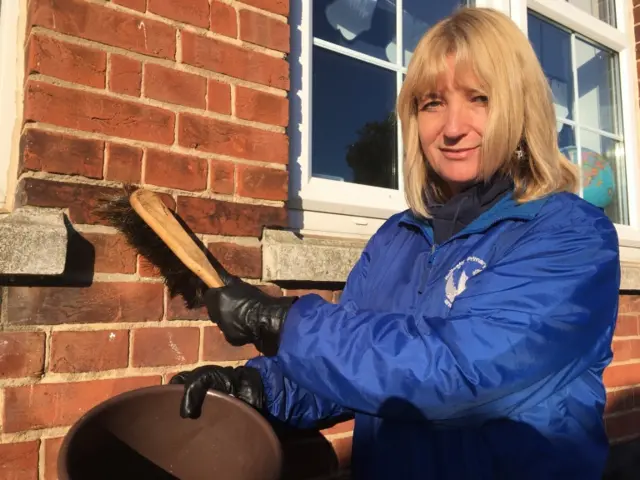 Louise Hinton with scrubbing brush