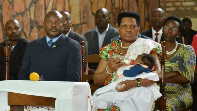 Burundi's First Lady Denise Nkurunziza feeds a baby in church