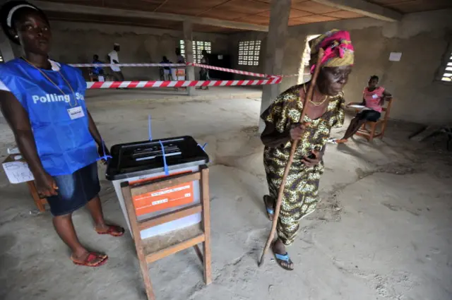 A woman leaves a polling station after casting her vote in the village of Fefeh Town on November 8, 2011