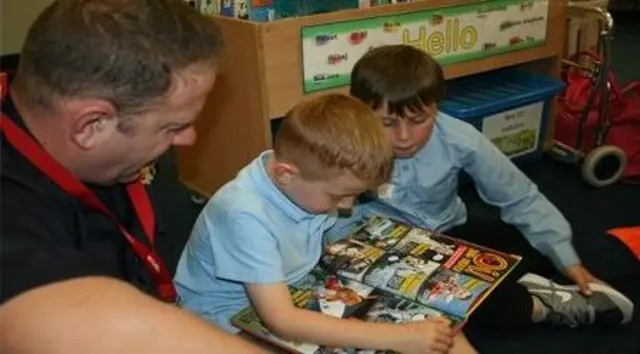 Firefighter reading with children