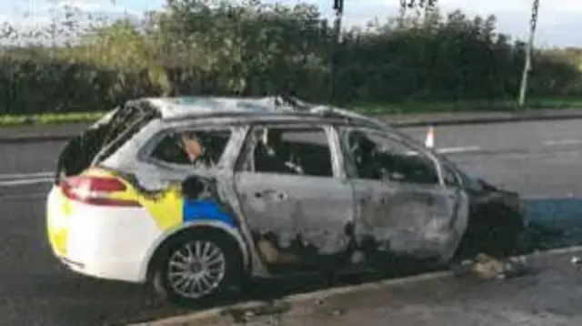 Burnt out police car