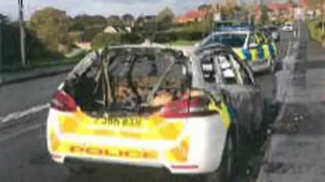 Burnt out police car