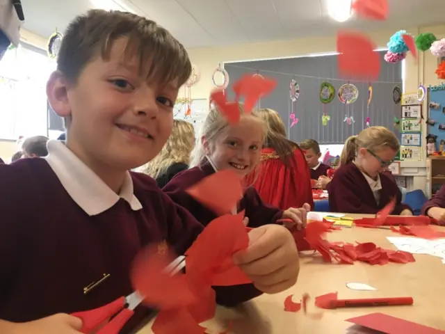 Pupils make paper poppy petals