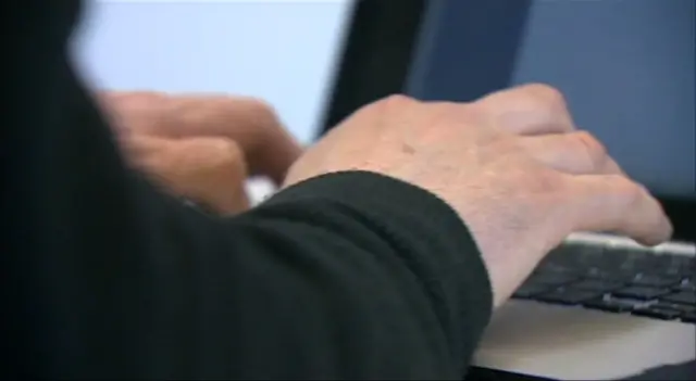 Close up image of hands at a laptop