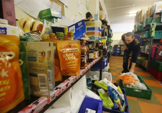 Shelves and boxes of food at a foodbank