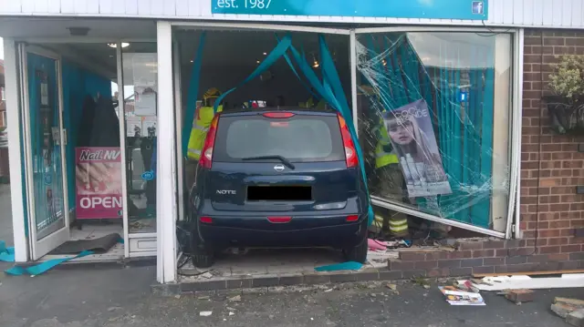 Photo of the car in the front of the shop