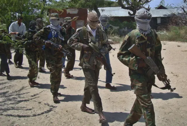 Al-Qaeda linked al-shabab recruits walk down a street on March 5, 2012 in the Deniile district of the Somalian capital, Mogadishu, following their graduation.