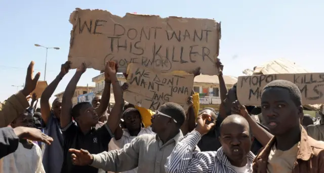 Youths carry placards demanding the dismissal of Plateau state Governor Jonah Jang in the central Nigerian city of Jos on December 1, 2008.