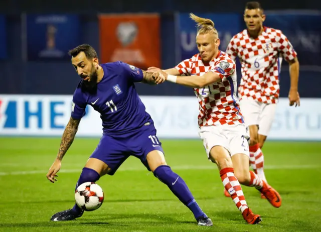 Greece and Croatia players compete for the ball