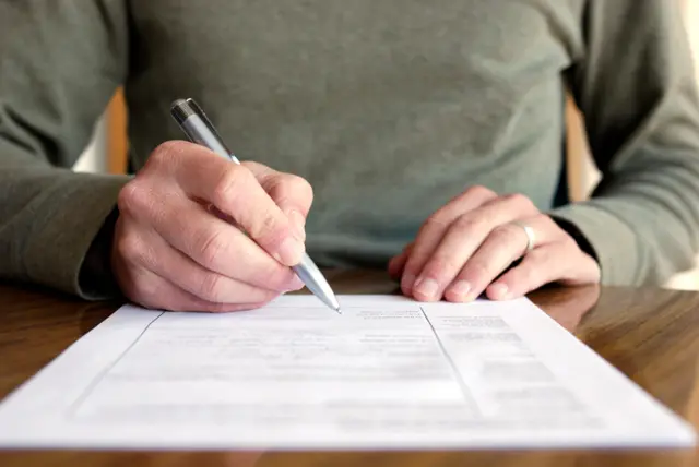 A man filling out an application form