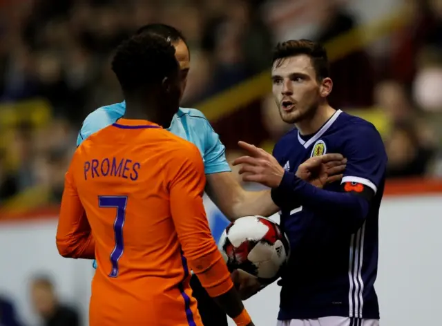 Andrew Robertson makes a point to Netherlands' Quincy Promes