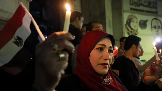 People hold candles in the memory of victims of the attack in north Sinai in front of the Press Syndicate in Cairo, Egypt, 27 November 2017