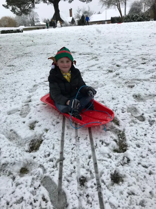 Boy on sledge in west London