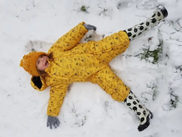 A little girl's first day in the snow.