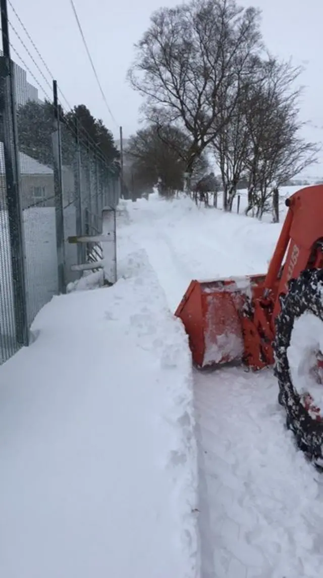 a digger clearing snow in Pontrhydfendigaid, Ceredigion